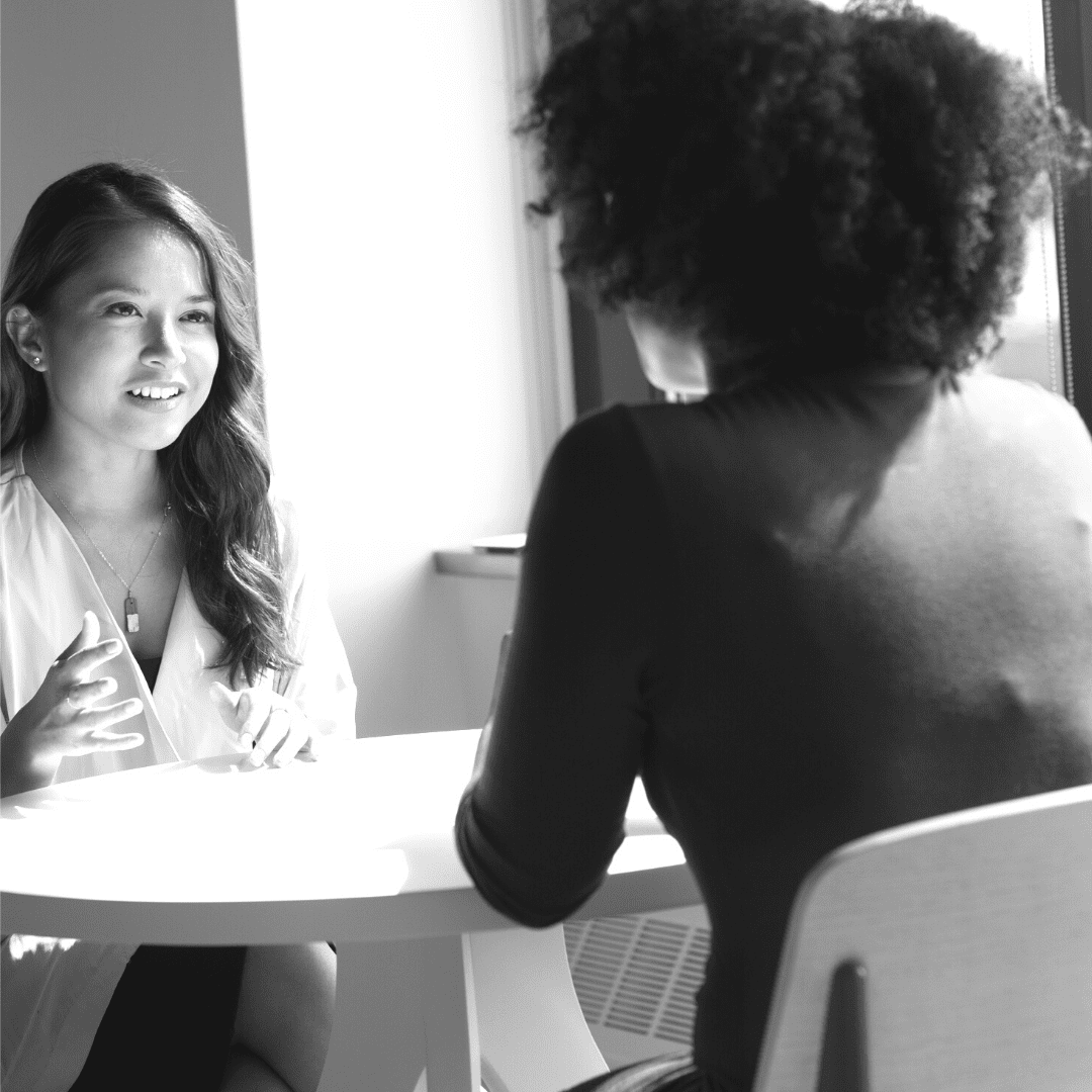 woman talking to another person on how to help a friend with suicidal thoughts